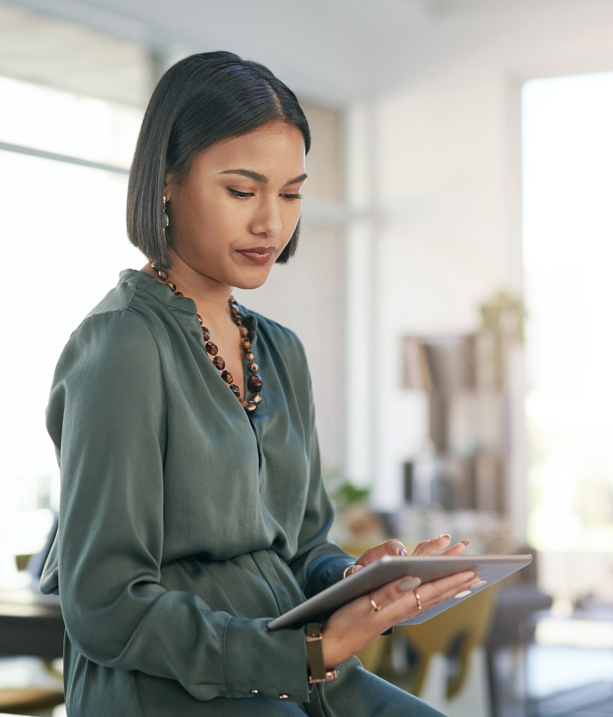 Woman works on her tablet in her office